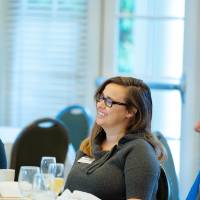 crowd eats brunch and listens to panel